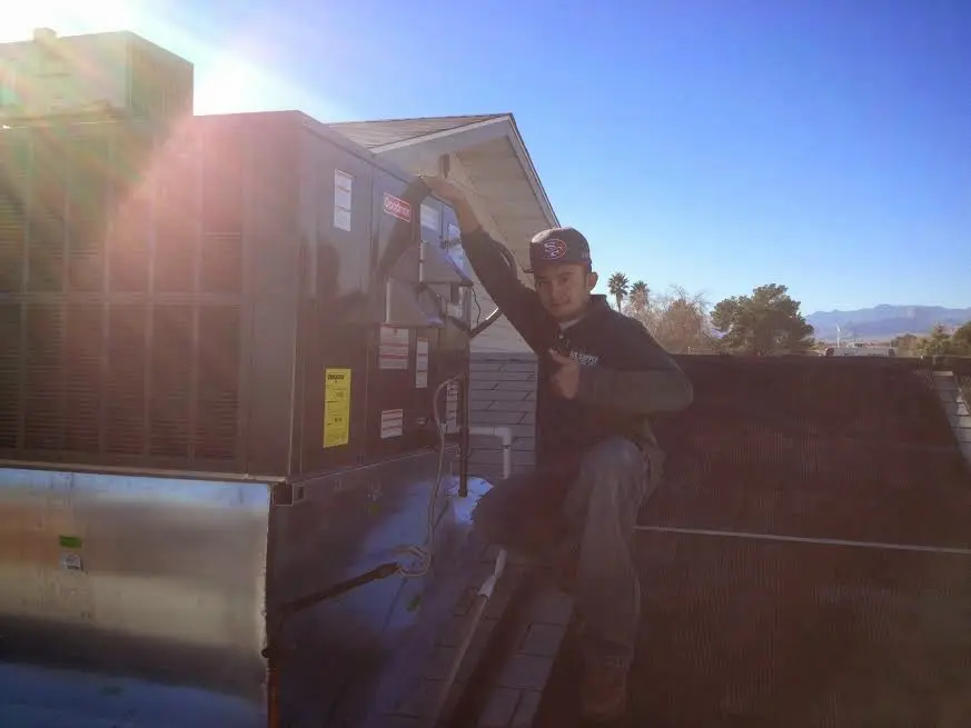 HVAC technician performing HVAC Inspection on a rooftop unit in Canyon Lake
